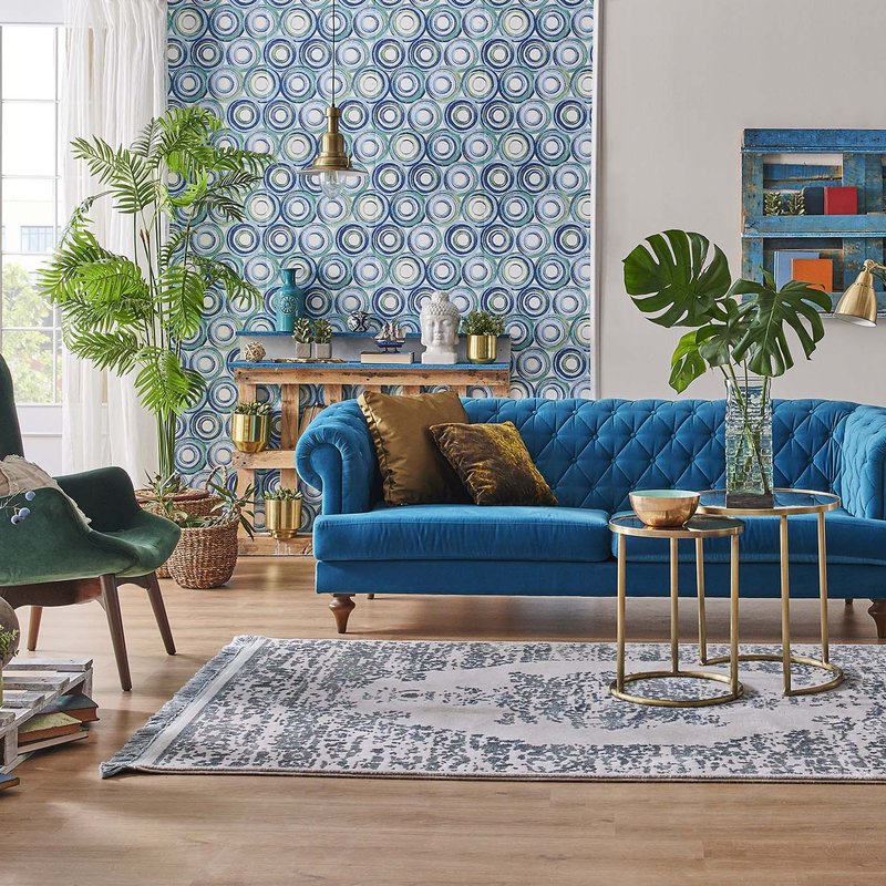 blue couch and brown coffee table on a brown hardwood floor from Stoller Floors in Orrville, OH