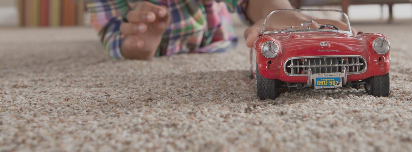 playing on carpet with toys