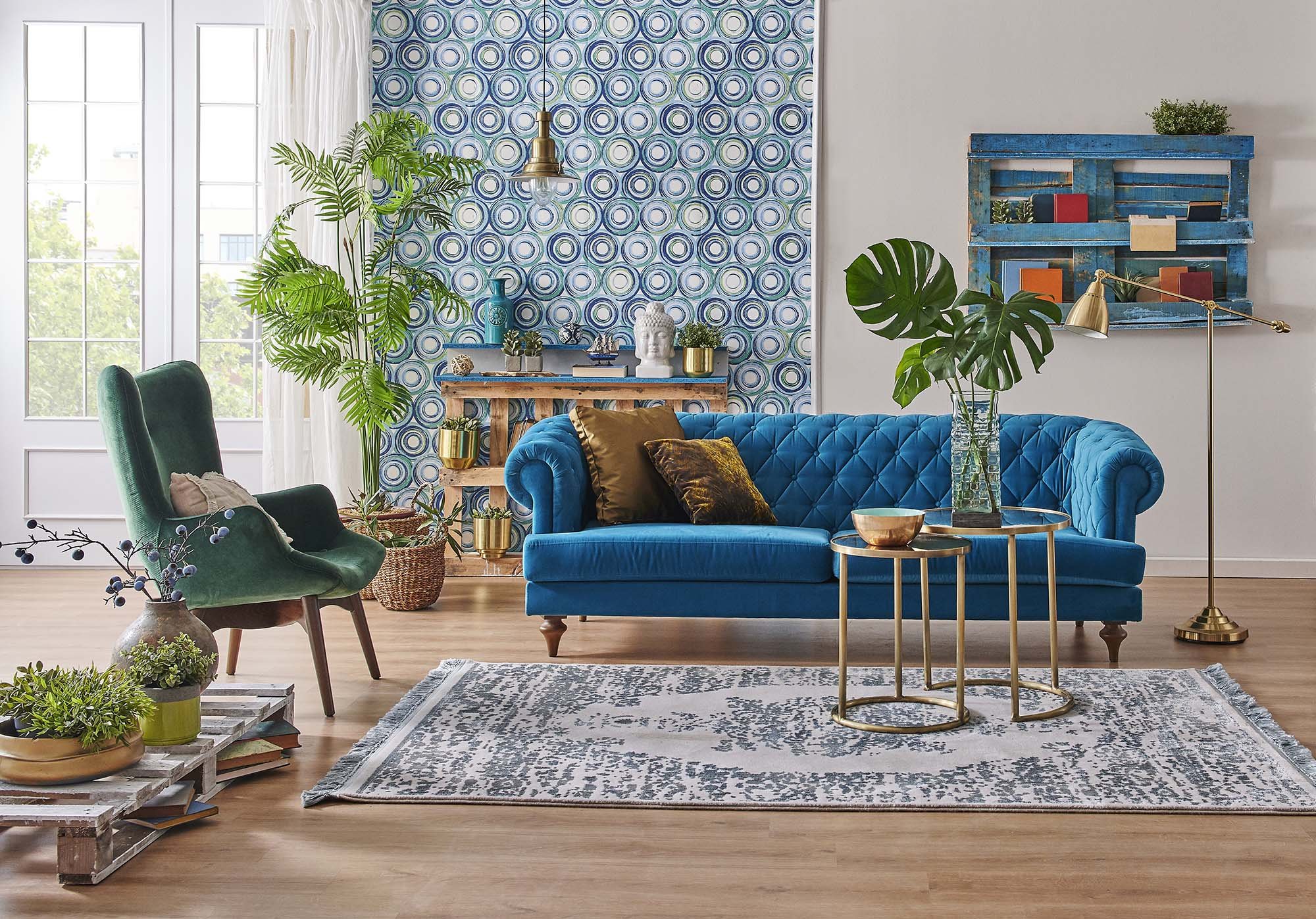 blue couch and green armchair in a living room with gray rug and brown hardwood floor from Stoller Floors in Orrville, OH