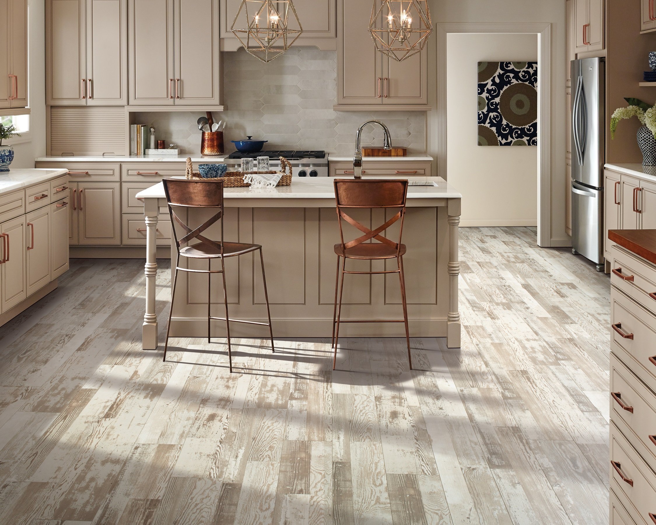 kitchen island with brown chairs and beige cabinets on a hardwood floor from Stoller Floors in Orrville, OH